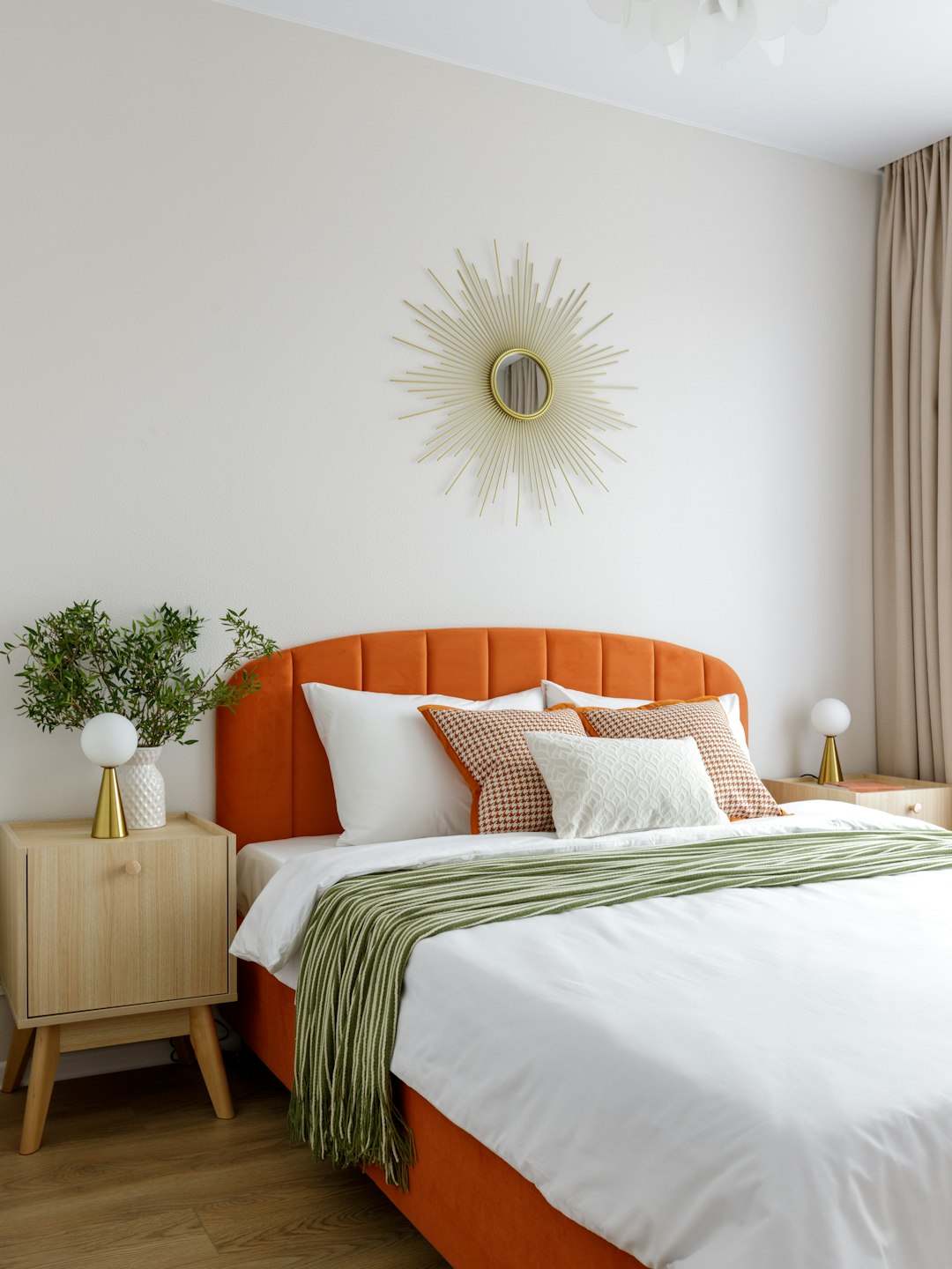 High-resolution a modern bedroom with an orange bed and sunburst mirror photo by Aleksandra Dementeva in Featured | PictureHub